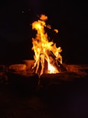 a fire is lit in the dark with bright flames