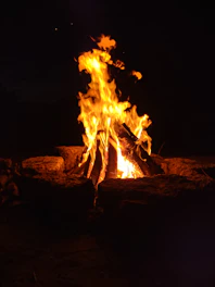 a fire is lit in the dark with bright flames