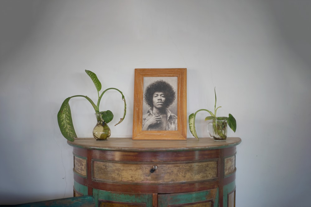 a picture of a man with a afro is on a dresser