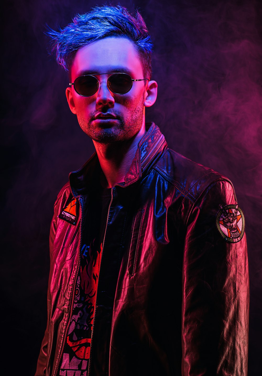 a man wearing sunglasses and a leather jacket