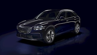 a blue car is shown in a dark room