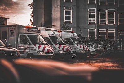 a row of ambulances parked in a parking lot