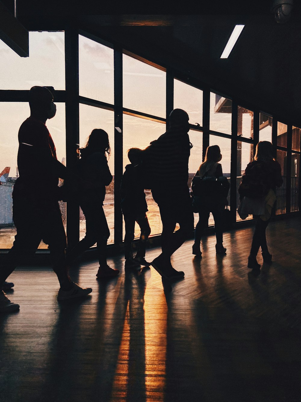 a group of people standing next to each other near a window