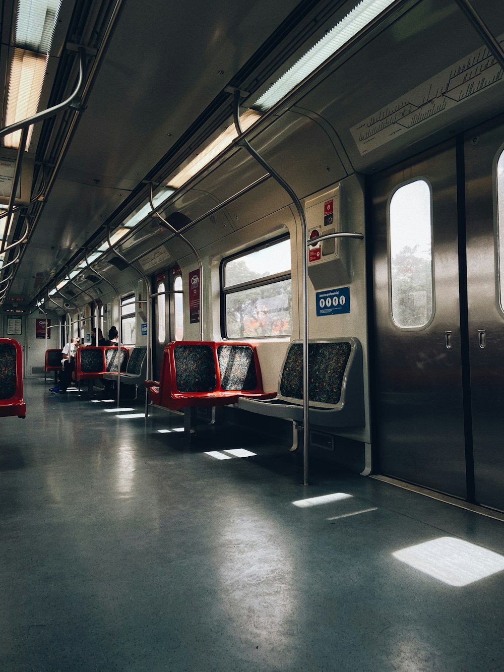 a train with lots of windows and red seats