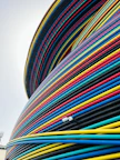 a large stack of colorful hoses sitting on top of a building