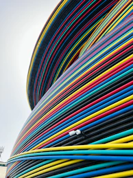 a large stack of colorful hoses sitting on top of a building