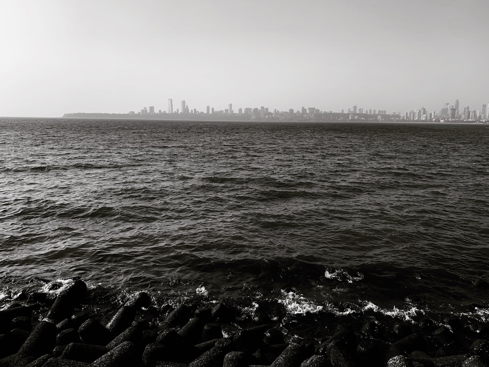 a large body of water with a city in the background