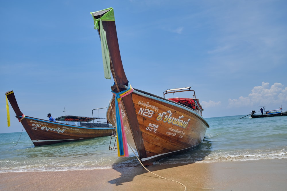 a couple of boats that are sitting in the sand