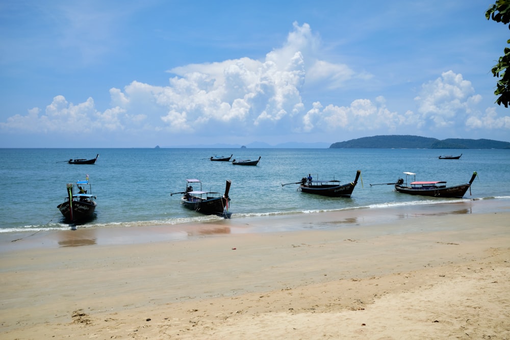a group of boats sitting on top of a beach