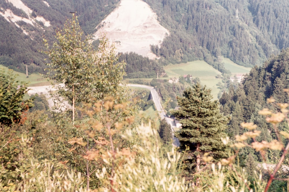 a scenic view of a winding road in the mountains