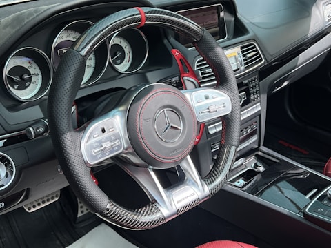 Close-up of a luxury car dashboard with illuminated digital controls.