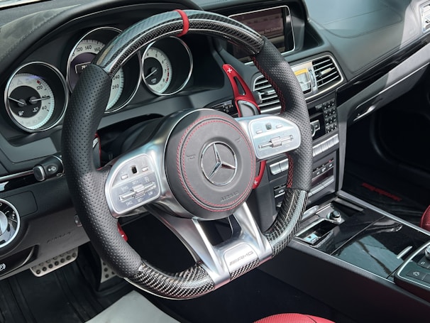 Close-up of a luxury sports car dashboard with leather and chrome details