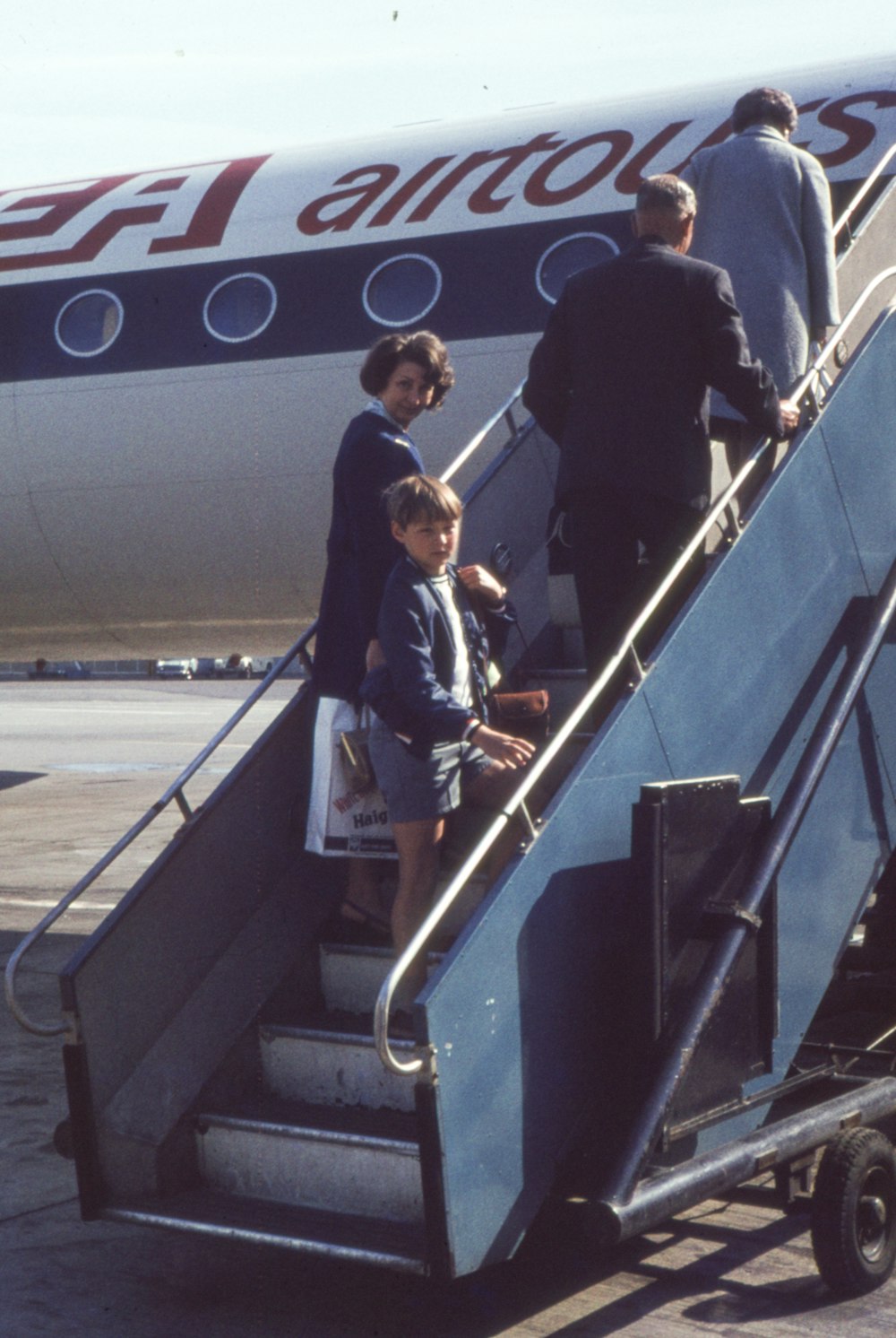 a group of people getting off of an airplane