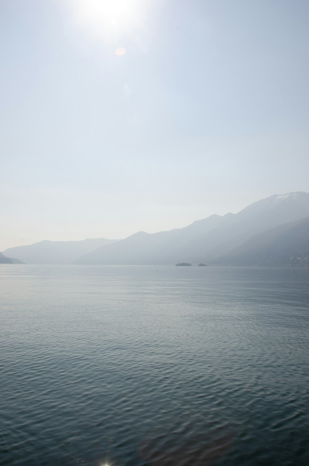 a large body of water with mountains in the background