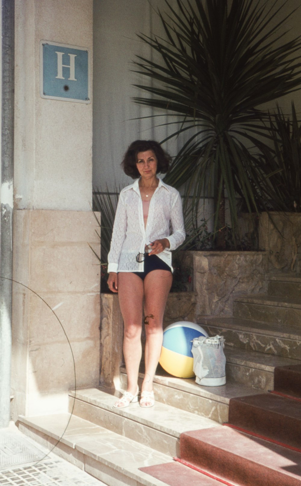 a woman standing on the steps of a building