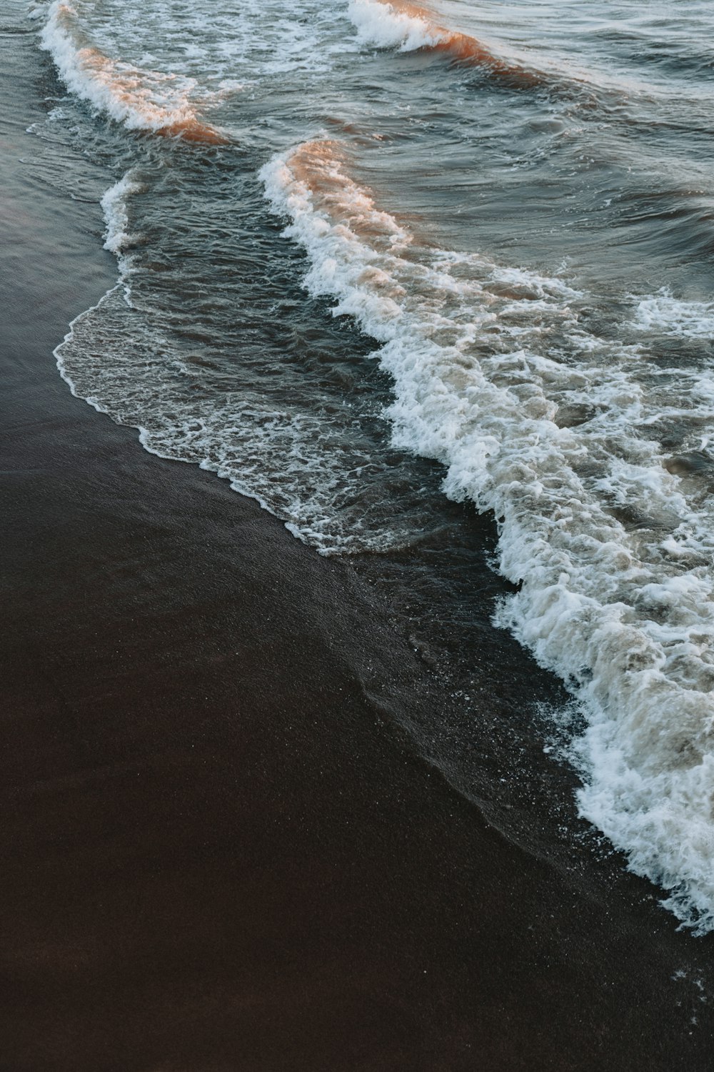 a person riding a surfboard on top of a wave