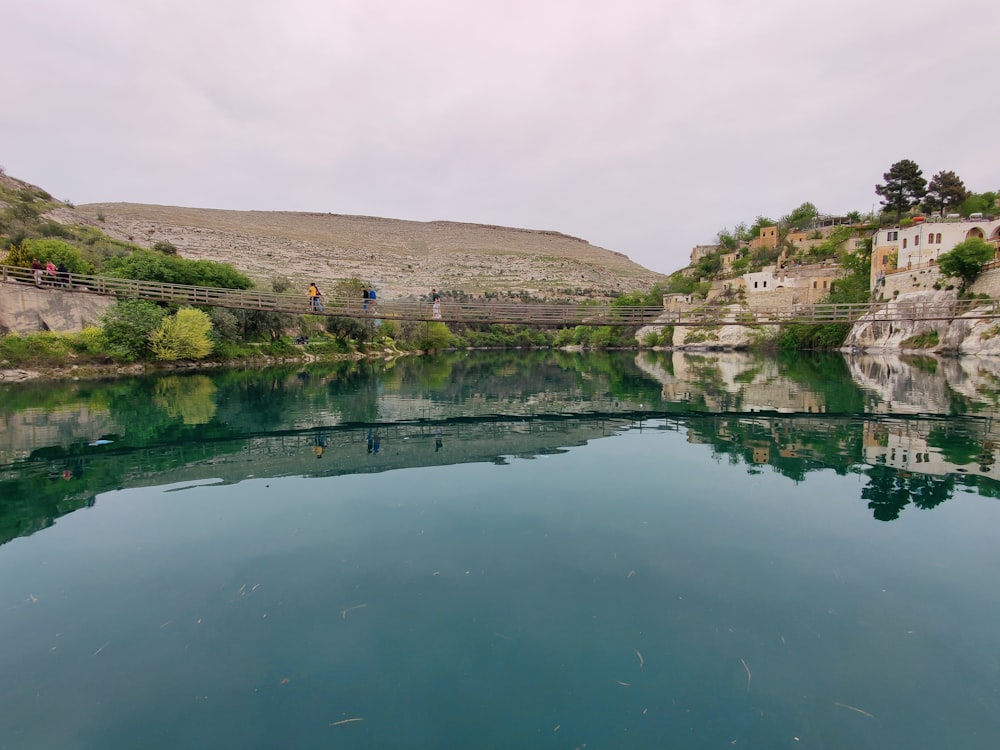 a body of water with a bridge over it