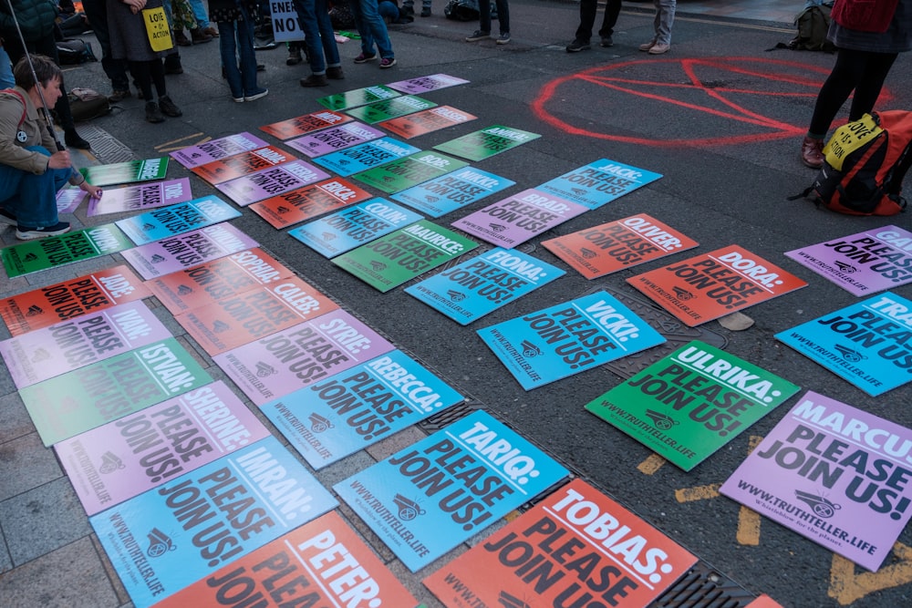 a group of people standing around a bunch of signs