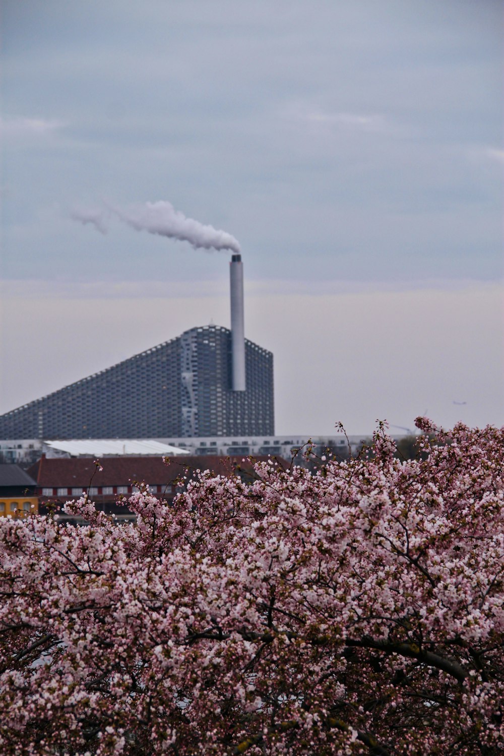 a factory with smoke coming out of it's stacks