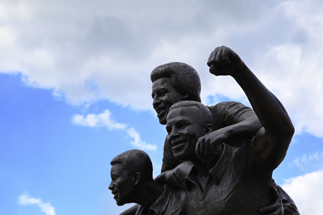 a statue of a man holding a child, Statue