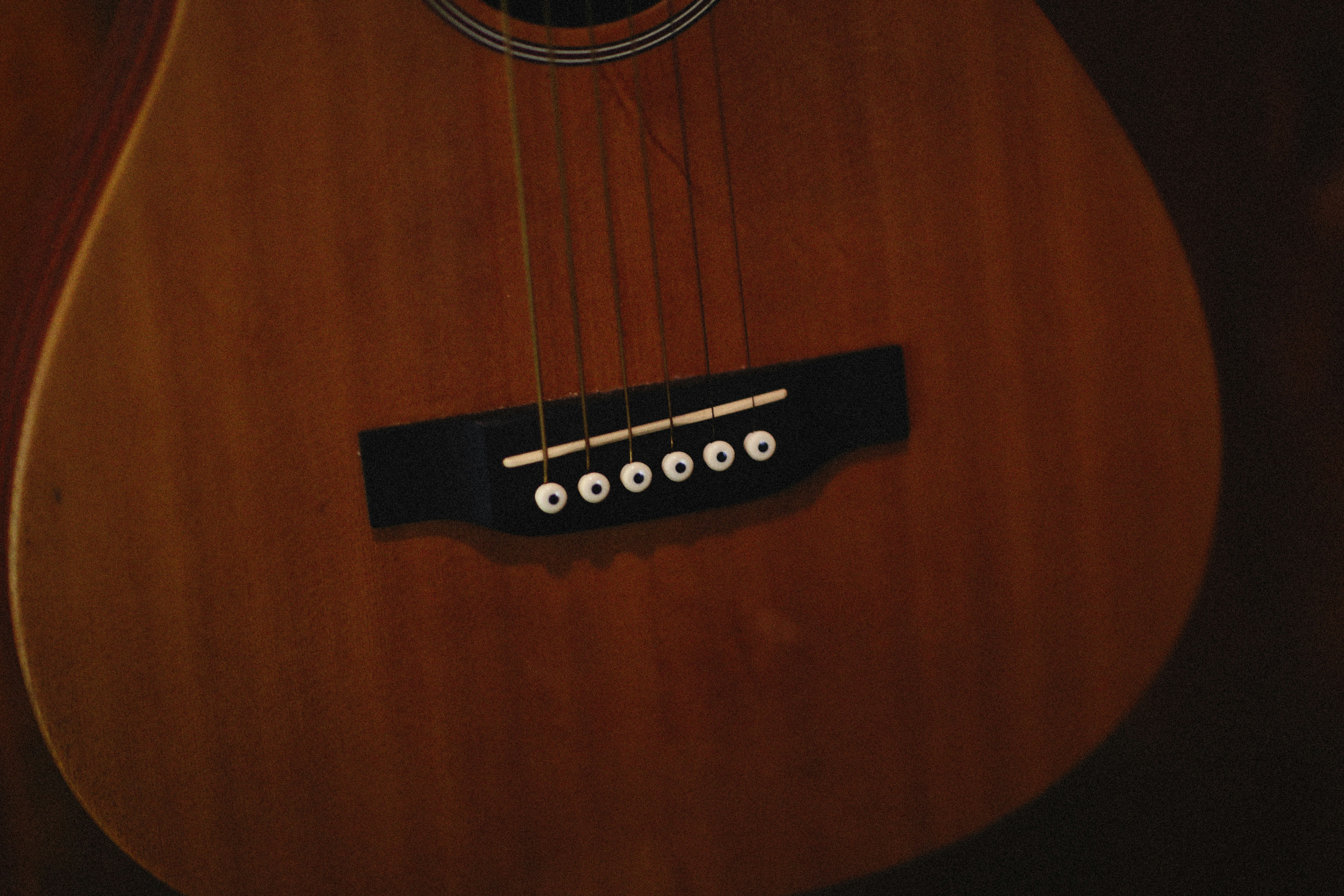 a close up of an acoustic guitar with strings