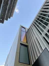 looking up at a tall building with a sky background