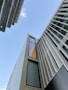 looking up at a tall building with a sky background