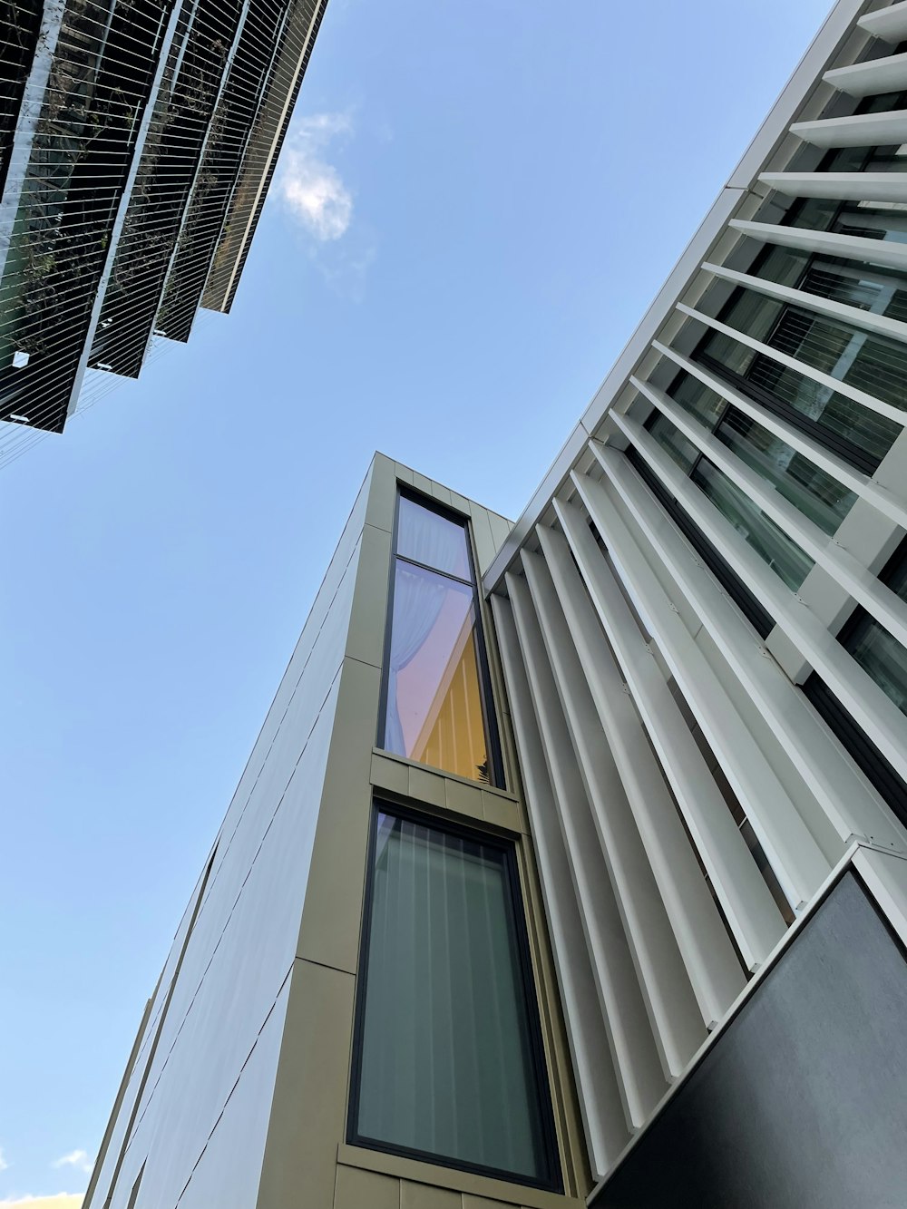 looking up at a tall building with a sky background