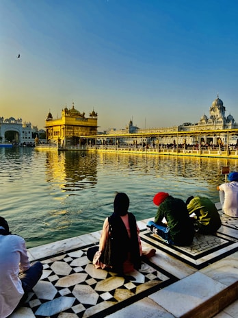 Devotees offering prayers at the serene banks of the Ganges during sunrise.