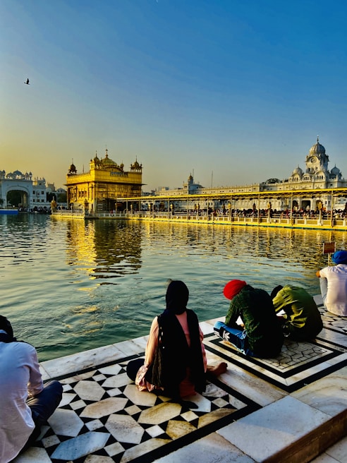 Senior citizens peacefully meditating by the serene banks of the Ganges in Haridwar