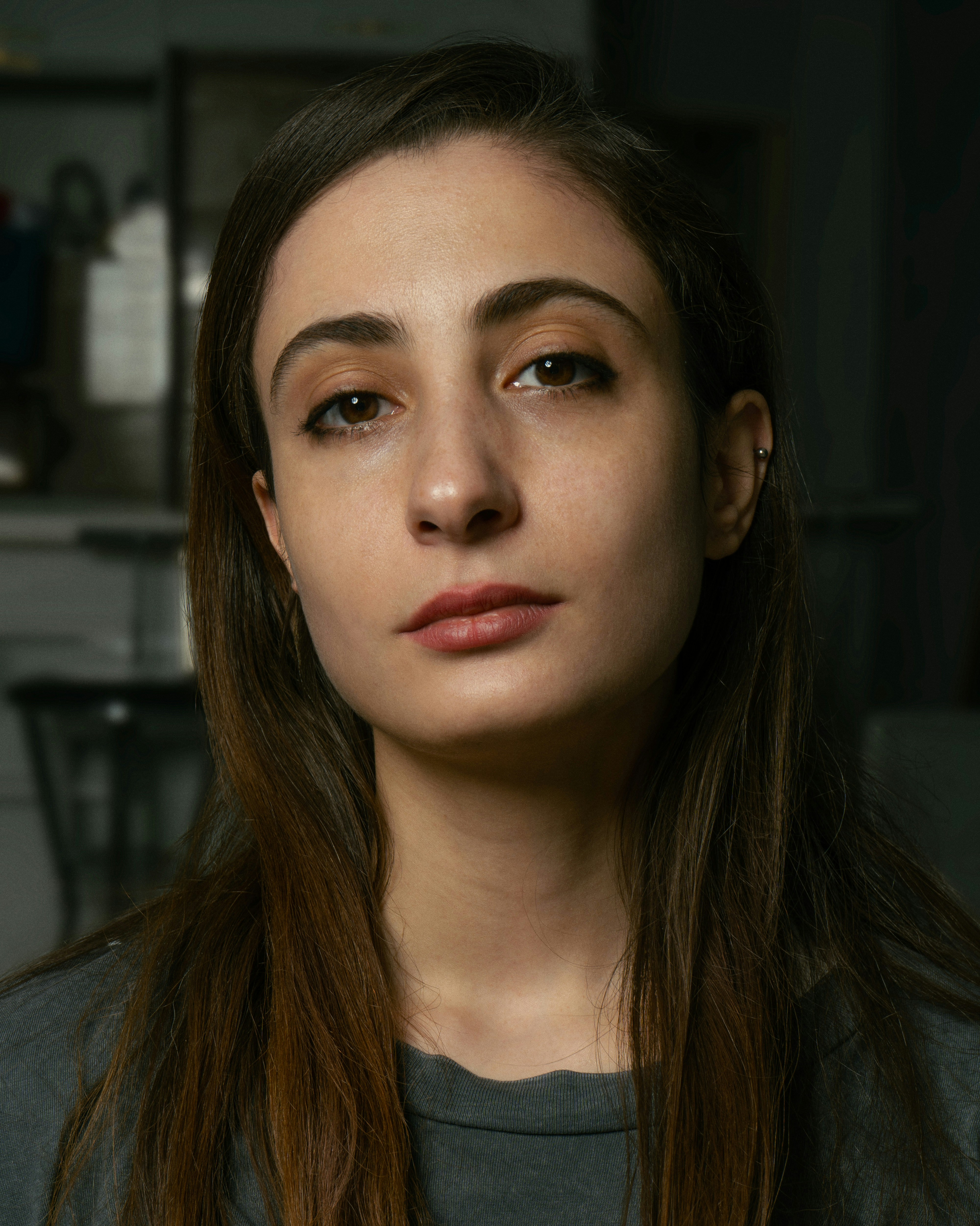 a woman with long hair and a gray shirt