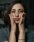 a woman with her hands on her face