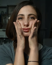a woman with her hands on her face