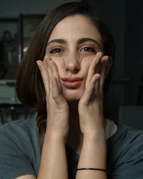a woman with her hands on her face