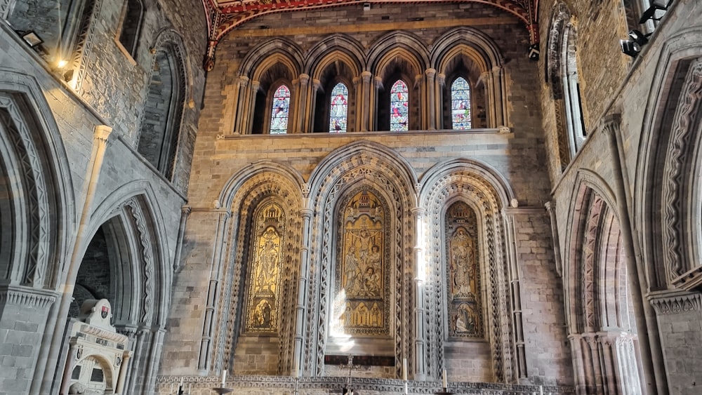 the interior of a large cathedral with stained glass windows