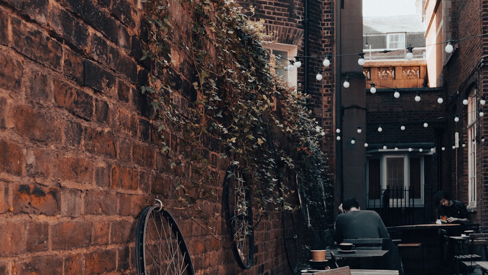 a narrow alleyway with tables and chairs