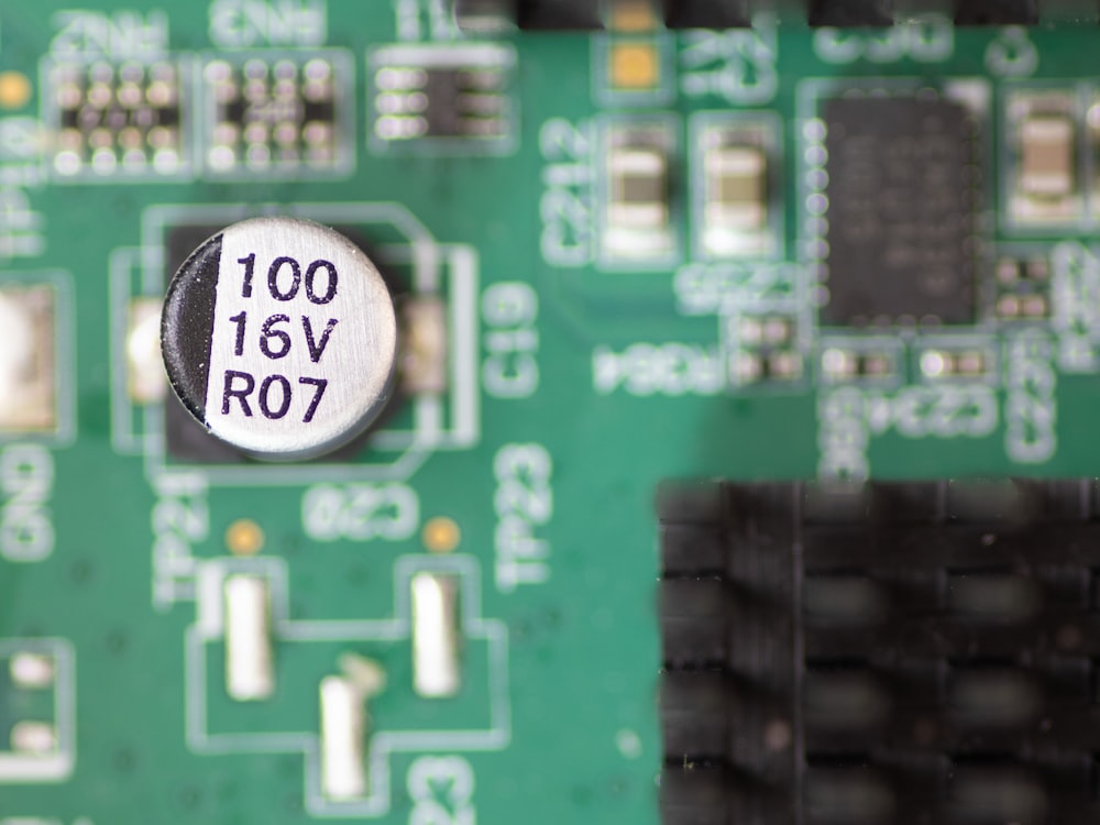 a close up of a circuit board with a button