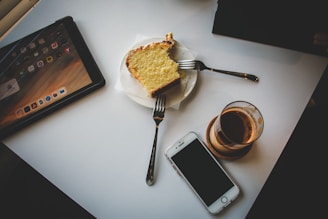 a plate with a piece of cake next to a cup of coffee