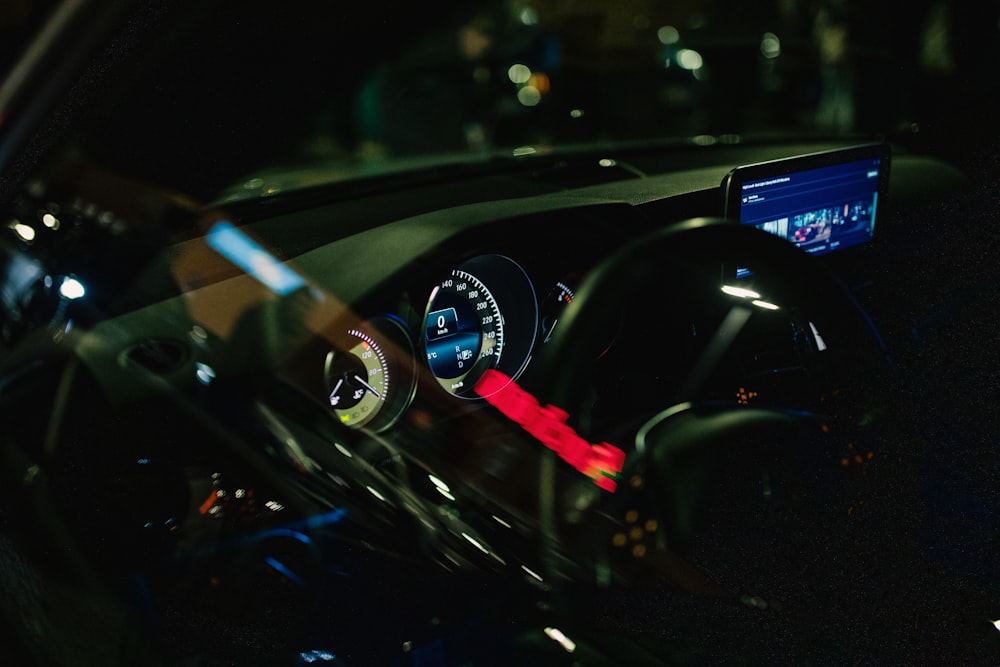 a car dashboard with a red arrow on it