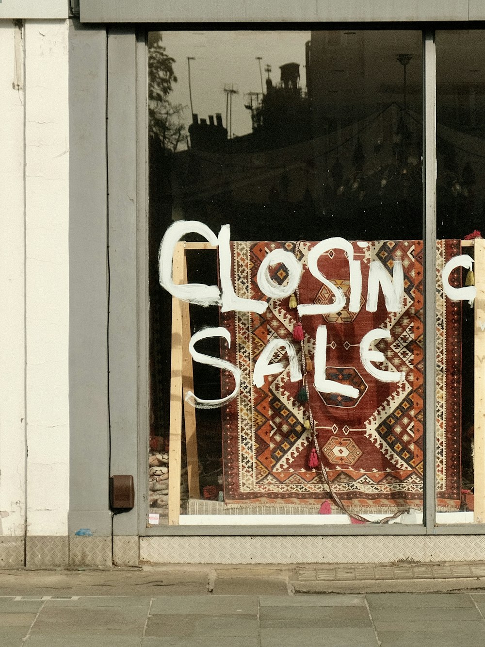 a close up of a store window with a sale sign