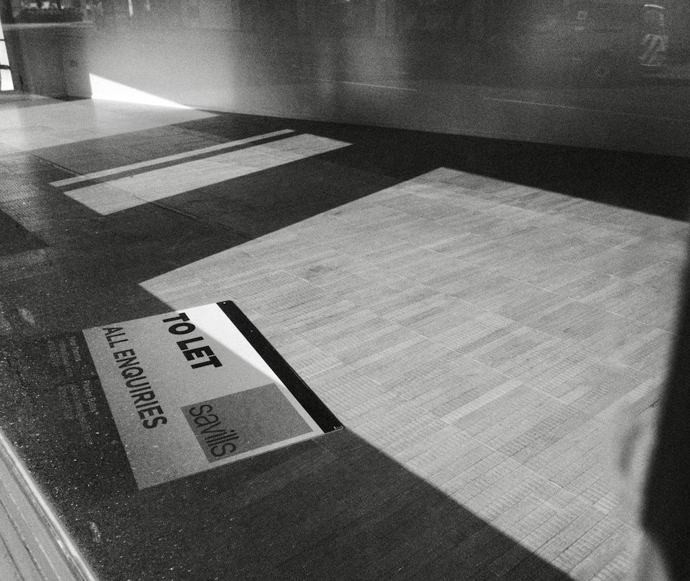a black and white photo of a sign on the floor