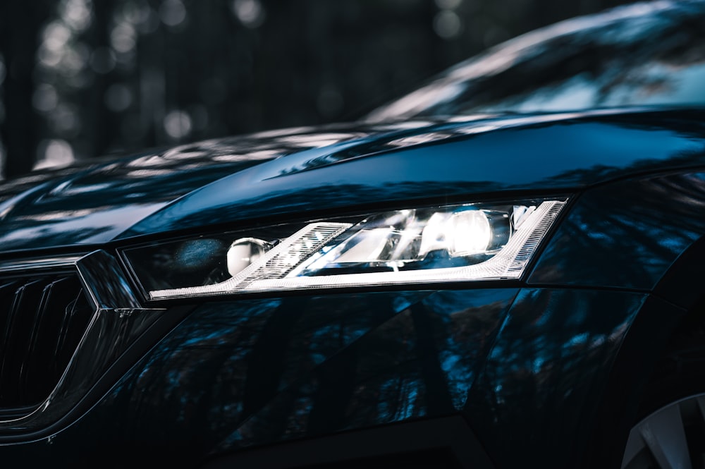 a close up of a blue car's headlight