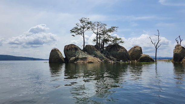 a group of rocks sitting in the middle of a lake