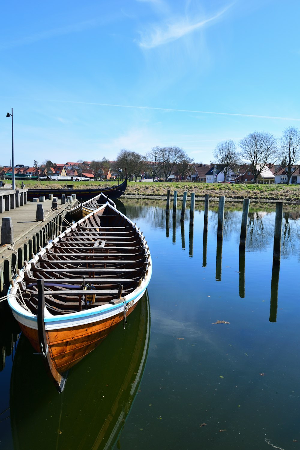 a boat is docked at a pier on the water