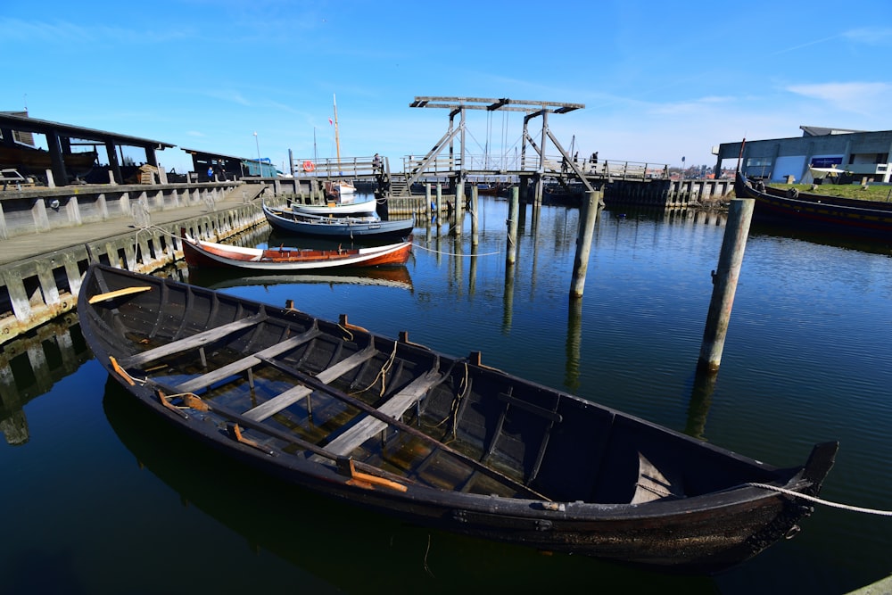 a row of boats sitting next to a dock