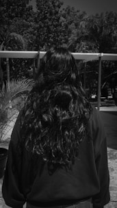 a black and white photo of a woman with long hair