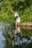 A serene nature scene with a person meditating by a tranquil lake.
