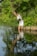 A serene nature scene with a person meditating by a tranquil lake.