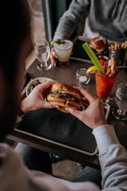 a man sitting at a table with a plate of food