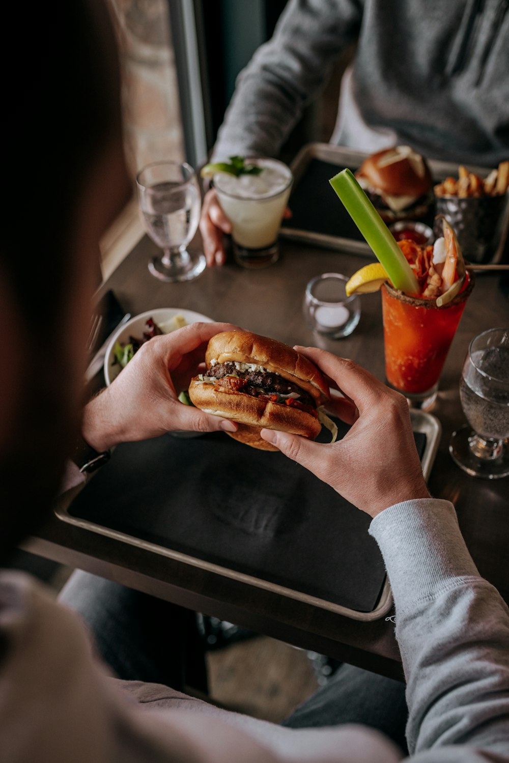 a man sitting at a table with a plate of food